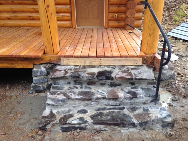 Lakeview wooden front porch with stone stairs